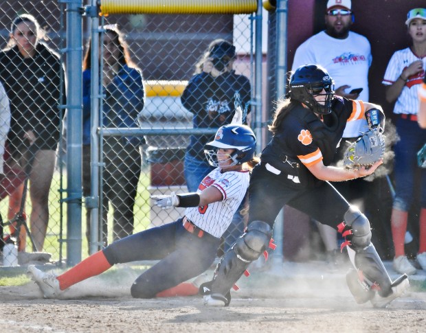 Oswego's Marissa Moffett slides home with a run after tagging up on a sacrifice fly by Jaelynn Anthony during a Class 4A Plainfield North Sectional semifinal game on Wednesday, May 29, 2024, in Plainfield.(Jon Cunningham/for The Beacon-News)