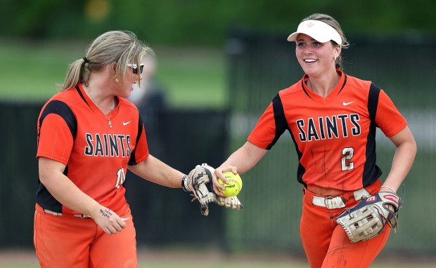 St. Charles East's Katie Morgan, (10), left and Addison Wolf (2) celebrate Wolf's inning ending catch during a DuKane Conference game against St. Charles North on Monday, April 15, 2024 in St. Charles. St. Charles East won, 5-1.H. Rick Bamman / For the Beacon-News