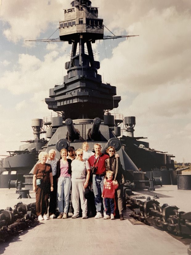 Bob Larson, second from left, poses with his family in 2002 in front of the USS Texas, which was one of six battleships that took part in D-Day 80 years ago (Robert E. Larson)