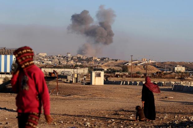 Smoke rises following an Israeli airstrike on buildings near the separating wall between Egypt and Rafah, southern Gaza Strip, Tuesday, May 7, 2024. (AP Photo/Ramez Habboub)