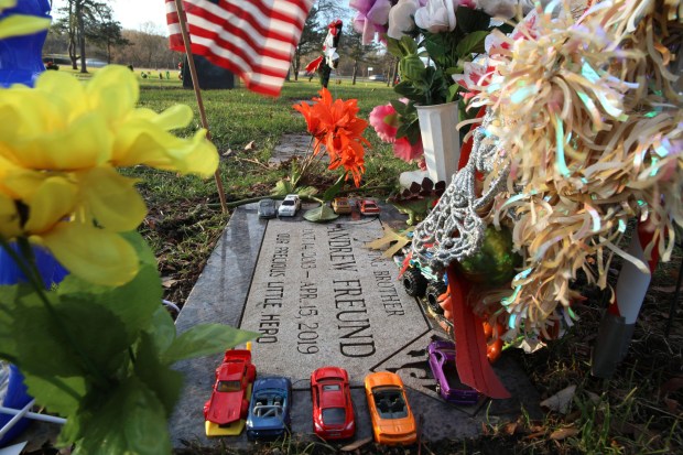 Colorful toy cars, superhero figures, toys, flowers and flags adorn the gravestone of 5-year-old Andrew "AJ" Freund at St. Michael the Archangel Catholic Cemetery and Mausoleum on Dec. 5, 2019 in Palatine.