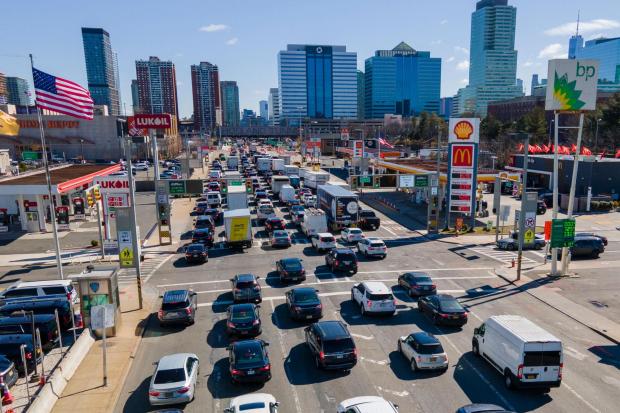 FILE - Commuters wait to drive through the Holland Tunnel into New York City during morning rush hour traffic in Jersey City, N.J.,, Wednesday, March 8, 2023. A study published Wednesday, May 22, 2024, says U.S. vehicles hit a record average age of 12.6 years in 2024 as people continue to hang on to their rides largely because new ones cost so much. (AP Photo/Ted Shaffrey, File)