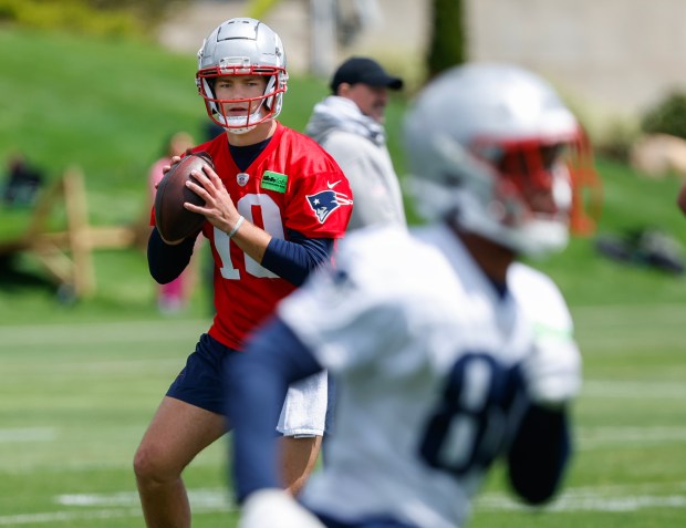 Patriots quarterback Drake Maye looks to throw a pass to tight end Jaheim Bell during rookie minicamp at Gillette Stadium on May 11, 2024. (Paul Connors/Boston Herald)