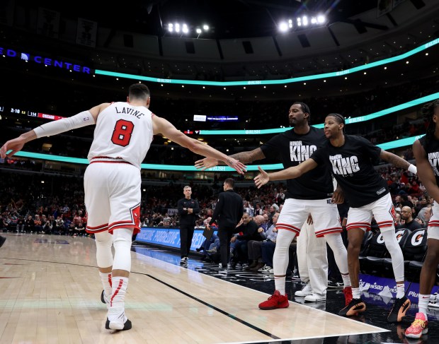 Bulls guard Zach LaVine is congratulated by his teammates after scoring while being fouled in overtime of a game against the Rockets at the United Center on Jan. 10, 2024. (Chris Sweda/Chicago Tribune)