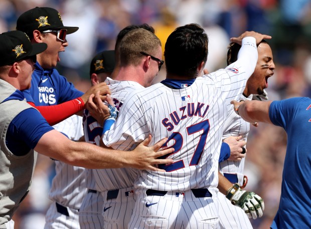 Chicago Cubs third baseman Christopher Morel (right) celebrates with his teammates after hitting a game-winning walk off single in the ninth inning of a game against the Pittsburgh Pirates at Wrigley Field in Chicago on May 18, 2024. (Chris Sweda/Chicago Tribune)