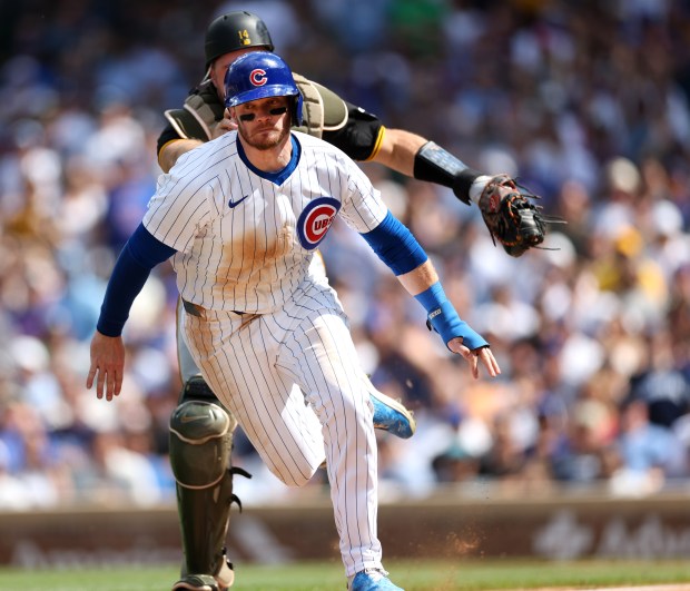 Chicago Cubs left fielder Ian Happ is chased by Pittsburgh Pirates catcher Joey Bart before Happ was tagged out on a rundown in the 8th inning of a game against the Pittsburgh Pirates at Wrigley Field in Chicago on May 18, 2024.  (Chris Sweda/Chicago Tribune)