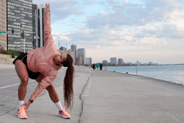 Kayla Jeter stretches before running along Chicago's lakefront on April 23, 2024. (Antonio Perez/Chicago Tribune)