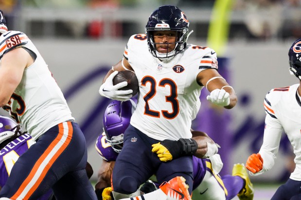 Bears running back Roschon Johnson tries to fight through a tackle against the Vikings on Nov. 27, 2023, in Minneapolis. (Eileen T. Meslar/Chicago Tribune)