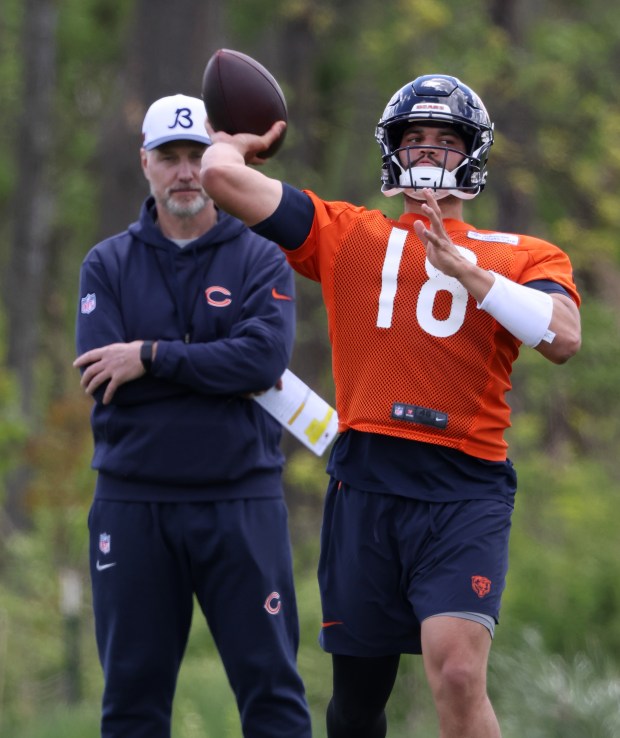 Quarterback Caleb Williams throws to receivers as head coach Matt Eberflus watches during Bears rookie minicamp at Halas Hall Saturday, May 11, 2024, in Lake Forest. (John J. Kim/Chicago Tribune)