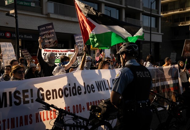 Activists in support of Palestine rally on Michigan Ave at Oak St. in protest of President Biden, who is in town for a fundraiser, on April 8, 2024. (E. Jason Wambsgans/Chicago Tribune)