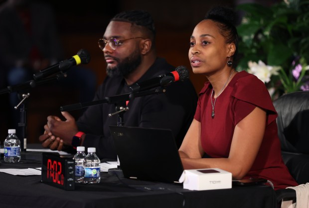 Anthony Driver Jr., left, and Remel Terry, both of the Community Commission for Public Safety and Accountability, listen at a public meeting for the search for a Chicago police superintendent at St. Sabina Catholic Church, April 19, 2023. (Chris Sweda/Chicago Tribune)