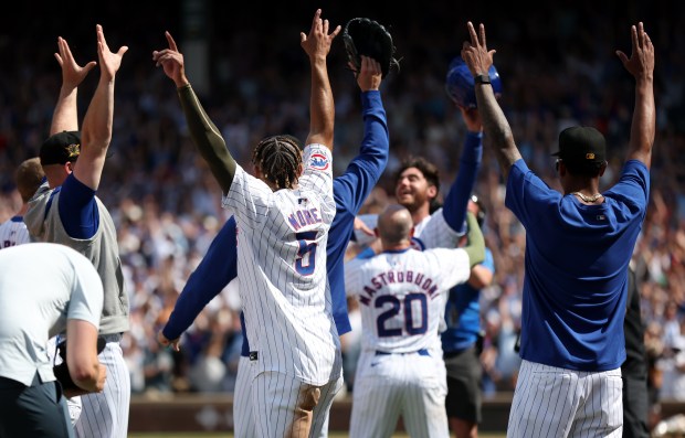 Chicago Cubs third baseman Christopher Morel (5) celebrates with his teammates following a confirmed ruling on his game-winning walk off single in the ninth inning of a game against the Pittsburgh Pirates at Wrigley Field in Chicago on May 18, 2024. (Chris Sweda/Chicago Tribune)