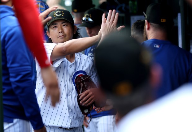 Chicago Cubs starting pitcher Shota Imanaga (18) is congratulated in the dugout by his teammates after closing out the Pittsburgh Pirates in the seventh inning of a game at Wrigley Field in Chicago on May 18, 2024. (Chris Sweda/Chicago Tribune)