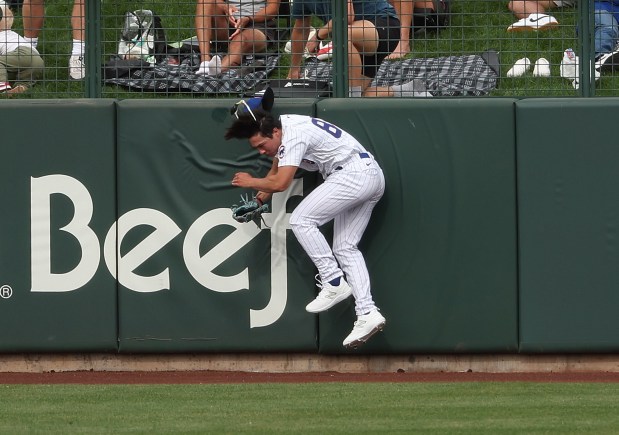 Cubs center fielder Brett Bateman crashes into the wall trying to catch a fly ball in a spring training game against the Padres on Feb. 25, 2024, in Mesa, Ariz. (Stacey Wescott/Chicago Tribune)