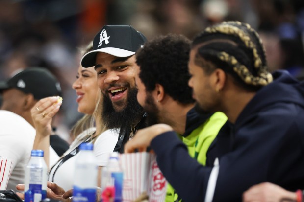 Bears players Keenan Allen, from left, Caleb Williams and Rome Odunze attend a Chicago Sky preseason game against the New York Liberty at Wintrust Arena on May 7, 2024. (Eileen T. Meslar/Chicago Tribune)