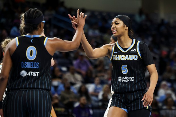 Chicago Sky forward Angel Reese (5) high-fives guard Diamond DeShields (0) during their game against New York Liberty at Wintrust Arena on May 7, 2024. (Eileen T. Meslar/Chicago Tribune)