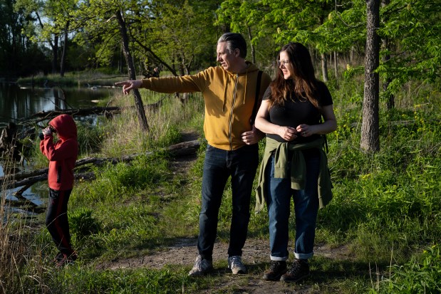 Jessica Sedgwick and Dan Ochwat with their son Selden, at West Ridge Nature Park on May 6, 2024. (E. Jason Wambsgans/Chicago Tribune)