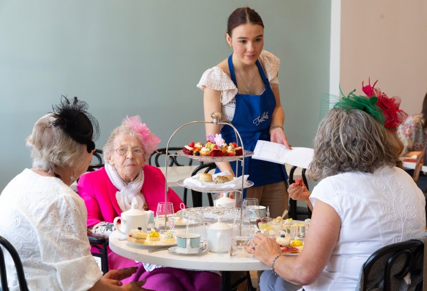 Angelina Kasiyan serves tea and food to Mary Lou Ness, 92, and her three daughters, Carol Nicolosi, Mary Ness-Bross and Joyce Biring at TeaLula on May 17, 2024, in Park Ridge. Mary Lou and her daughters were celebrating a late Mother's Day by having an afternoon tea. The afternoon tea included tea selections, finger sandwiches, warm scones, cream, homemade jam, lemon curd and desserts. (Stacey Wescott/Chicago Tribune)