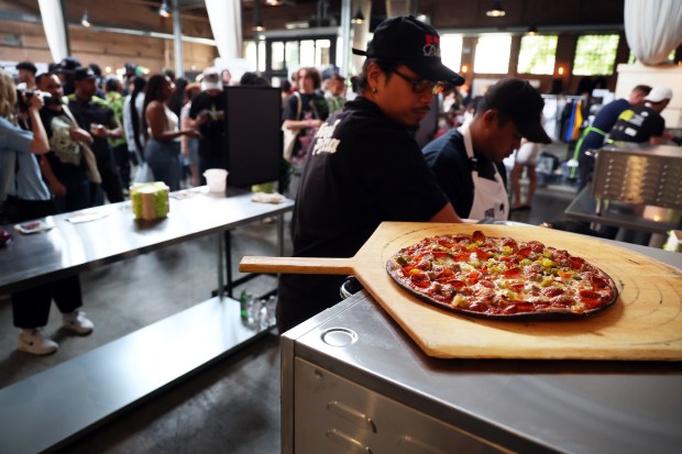 Workers from Chicago's Novel Pizza prepare to serve attendees at a The Utility Show, May 20, 2024, held on N. Bell Avenue in Chicago. (Terrence Antonio James/Chicago Tribune)