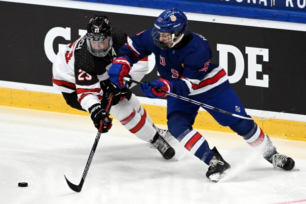 Carson Wetsch, left, of Canada vies with Cole Hutson of the U.S. during the IIHF U18 World Championship final on May 5, 2024, in Espoo, Finland. (Jussi Nukari/Lehtikuva via AP)