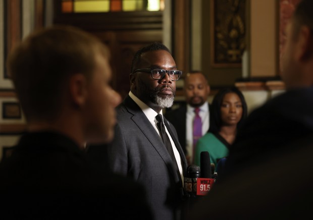 Mayor Brandon Johnson, center, answers reporters' questions at the Illinois State Capitol in Springfield after meeting with Gov. J.B. Pritzker on May 8, 2024. (John J. Kim/Chicago Tribune)