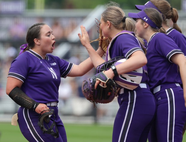 Northwestern starting pitcher Cami Henry, left, celebrates a great first inning with her teammates during a game against Indiana on May 4, 2024, in Evanston. The Hoosiers beat the Wildcats 8-3. (Stacey Wescott/Chicago Tribune)