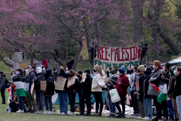 Dozens of students and supporters chant for disinvestment in support of Gaza at Deering Meadow at Northwestern University in Evanston on April 26, 2024. (Antonio Perez/Chicago Tribune)