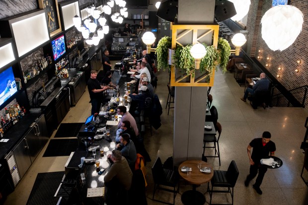 Patrons sit at the bar on April 26, 2024, at Industry Ales in Chicago. (Vincent Alban/Chicago Tribune)