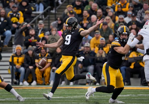 Iowa punter Tory Taylor (9) boots the ball against Rutgers during the first half of an NCAA college football game, Saturday, Nov. 11, 2023, in Iowa City, Iowa. (Bryon Houlgrave/AP)