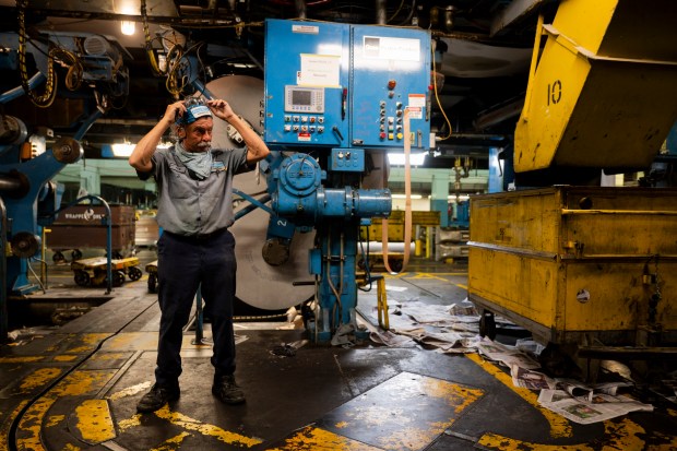 Night press operator Nick Ricci stands in the newsprint during the last Freedom Center press run of the Chicago Tribune on May 18, 2024. The facility printed its final edition of the Chicago Tribune before facing a demolition deadline and planned redevelopment into a casino. Tribune Publishing is shifting printing operations to the northwest suburban Daily Herald plant in Schaumburg. (Vincent Alban/Chicago Tribune)