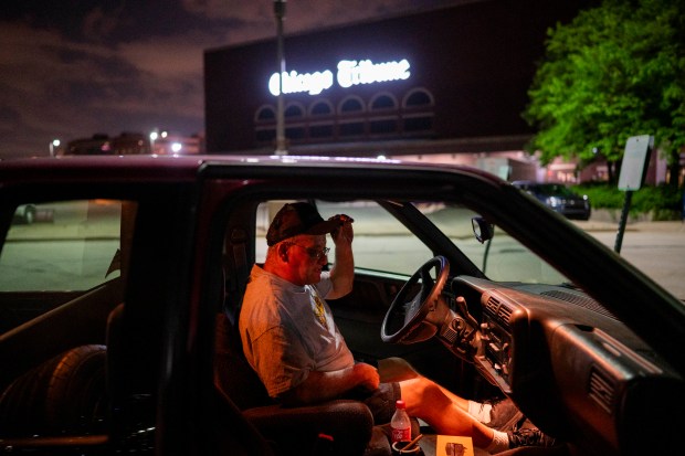 Rick Ramirez, a night shift press operator, sits in his car after helping print the last Freedom Center press run of the Chicago Tribune in the early morning hours of May 19, 2024. (Vincent Alban/Chicago Tribune)