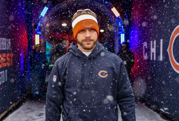 Bears kicker Cairo Santos walks out of the tunnel into the snow before facing the Falcons on Dec. 31, 2023, at Soldier Field. (Brian Cassella/Chicago Tribune)