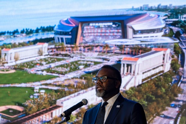 Mayor Brandon Johnson in front of an artist's rendering as the Bears announce plans to build a new lakefront domed stadium, April 24, 2024. (Brian Cassella/Chicago Tribune)