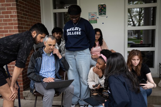 Beloit College professor Pablo Toral and students look at data from an air quality monitor they had placed on the school's campus, May 2, 2024. (E. Jason Wambsgans/Chicago Tribune)