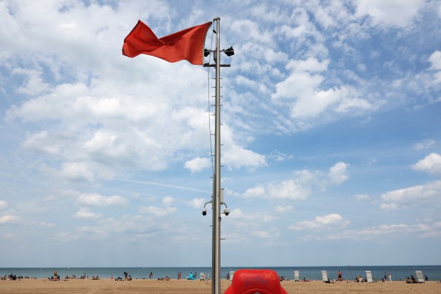 A red flag, meaning swimming is not allowed, is posted at Oak Street Beach, May 21, 2024, in Chicago. (John J. Kim/Chicago Tribune)
