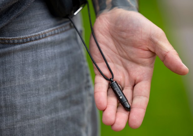 Former Chicago police Officer Joel Gordils wears the ashes of his late service dog, Goliath, on his belt, May 16, 2024. (Brian Cassella/Chicago Tribune)