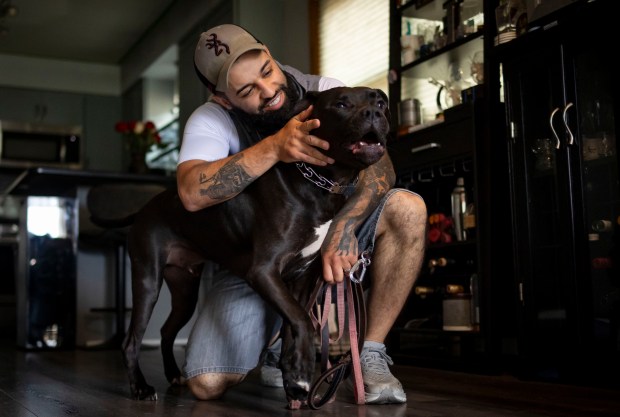 Former Chicago police Officer Joel Gordils plays with David at his home on May 16, 2024, in Chicago. (Brian Cassella/Chicago Tribune)