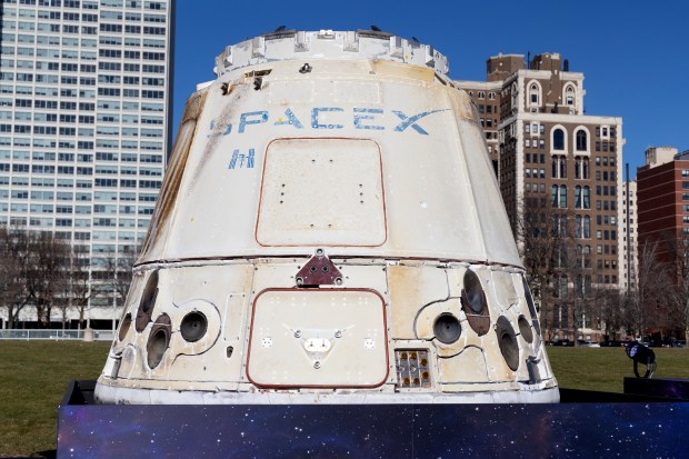 The SpaceX Dragon spacecraft is presented to a crowd of people gathered on the steps of the Museum of Science and Industry Thursday, Dec. 1, 2022, in Chicago. SpaceX's Dragon spacecraft is currently the only vehicle capable of returning large amounts of cargo to Earth, and is the first private spacecraft to take humans to the International Space Station. (Erin Hooley/Chicago Tribune)