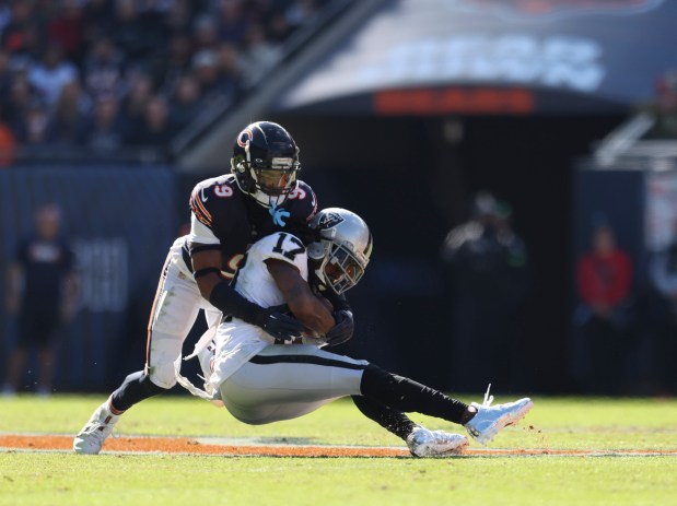 Chicago Bears safety Jaquan Brisker (9) tackles Las Vegas Raiders wide receiver Davante Adams (17) during the first quarter of a game between the Chicago Bears and the Las Vegas Raiders at Soldier Field on Sunday, Oct. 22, 2023. (Trent Sprague/Chicago Tribune)