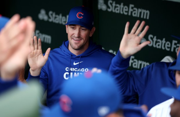 Chicago Cubs pitcher Kyle Hendricks high fives fellow players before heading to the bullpen before a game against the Atlanta Braves at Wrigley Field in Chicago on May 21, 2024. (Chris Sweda/Chicago Tribune)