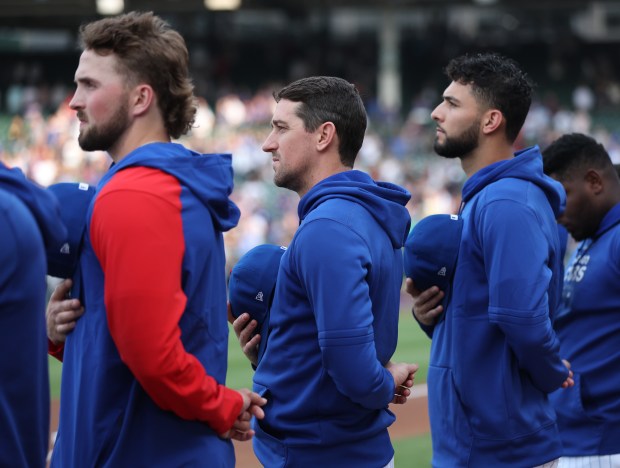 Chicago Cubs pitcher Kyle Hendricks (center) stands for the national anthem before a game against the Atlanta Braves at Wrigley Field in Chicago on May 21, 2024. (Chris Sweda/Chicago Tribune)