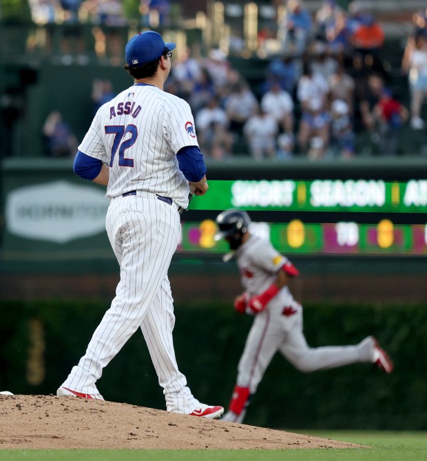 Chicago Cubs pitcher Javier Assad (72) walks off the mound as Atlanta Braves shortstop Orlando Arcia (background) rounds the bases after hitting a 2-run home run in the second inning of a game at Wrigley Field in Chicago on May 21, 2024. (Chris Sweda/Chicago Tribune)