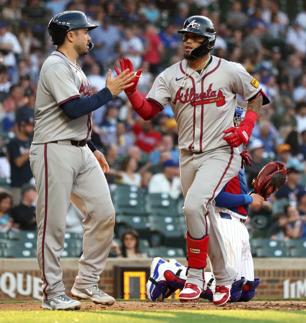 Atlanta Braves shortstop Orlando Arcia (right) is congratulated by a teammate after hitting a 2-run home run in the second inning of a game against the Chicago Cubs at Wrigley Field in Chicago on May 21, 2024. (Chris Sweda/Chicago Tribune)