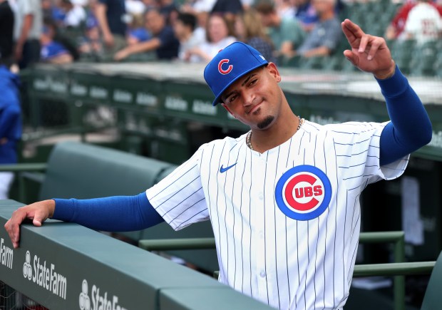 Chicago Cubs player Luis Vazquez waves to a fan before the start of a game against the Atlanta Braves at Wrigley Field in Chicago on May 21, 2024. (Chris Sweda/Chicago Tribune)