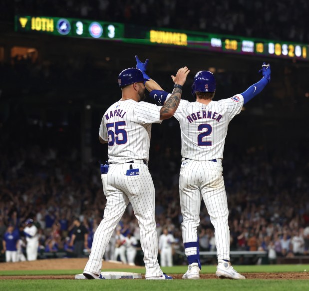 Chicago Cubs second baseman Nico Hoerner (2) celebrates after driving in the game-winning walk off infield single in the 10th inning of a game against the Atlanta Braves at Wrigley Field in Chicago on May 21, 2024. (Chris Sweda/Chicago Tribune)