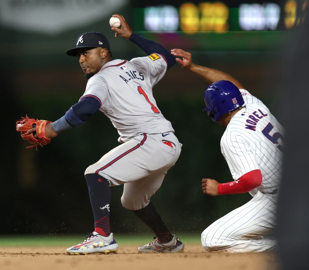 Atlanta Braves second baseman Ozzie Albies (1) looks toward first base after forcing out Chicago Cubs baserunner Christopher Morel (5) at second base in the 10th inning of a game at Wrigley Field in Chicago on May 21, 2024. (Chris Sweda/Chicago Tribune)