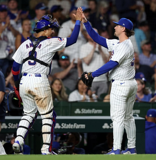 Chicago Cubs catcher Miguel Amaya (9) and relief pitcher Mark Leiter Jr. (right) celebrate after closing out the Atlanta Braves in the seventh inning of a game at Wrigley Field in Chicago on May 21, 2024. (Chris Sweda/Chicago Tribune)