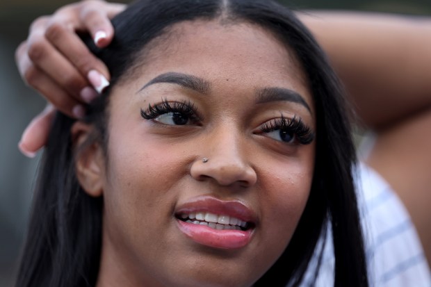 New Chicago Sky player Angel Reese hangs out on the field before throwing out a ceremonial first pitch before a game between the Chicago Cubs and the Atlanta Braves at Wrigley Field in Chicago on May 21, 2024. (Chris Sweda/Chicago Tribune)