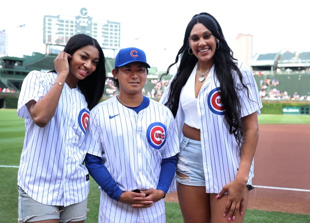 Chicago Cubs pitcher Shota Imanaga poses with new Chicago Sky players Angel Reese (left) and Kamilla Cardoso (right) prior to the Sky players throwing out ceremonial first pitches before a game between the Cubs and the Atlanta Braves at Wrigley Field in Chicago on May 21, 2024. (Chris Sweda/Chicago Tribune)