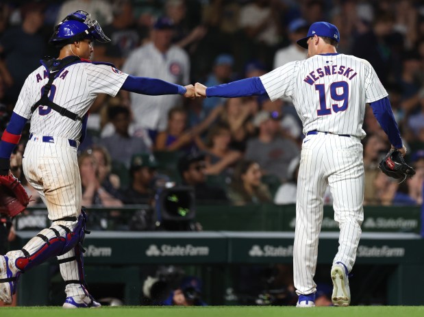 Chicago Cubs catcher Miguel Amaya (9) and relief pitcher Hayden Wesneski (19) congratulate one another after shutting down the Atlanta Braves in the 8th inning of a game at Wrigley Field in Chicago on May 21, 2024. (Chris Sweda/Chicago Tribune)